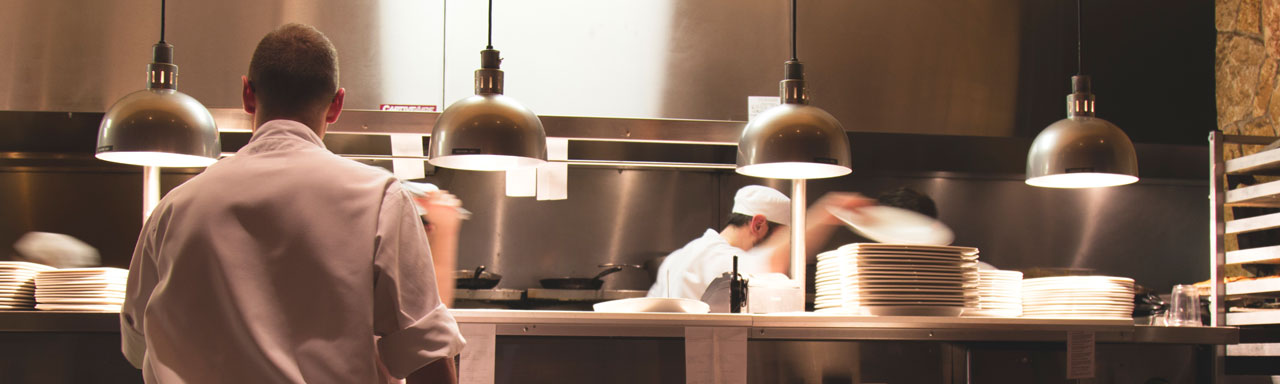 Line cooks working in an industrial kitchen.