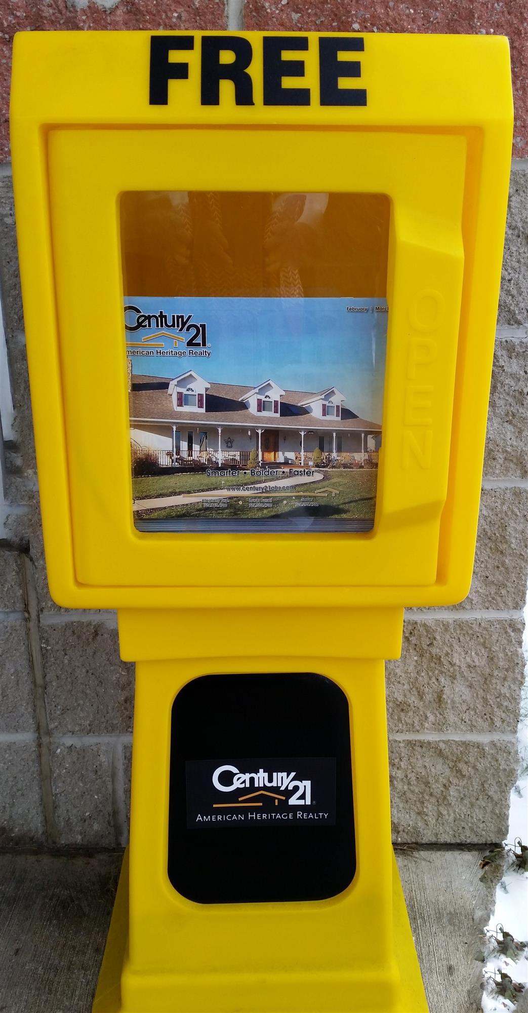Newspaper Vending Machine containing Century 21 American Heritage Realty Magazine.