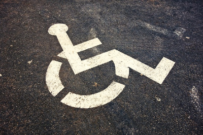 handicap accessible logo painted in white on asphalt