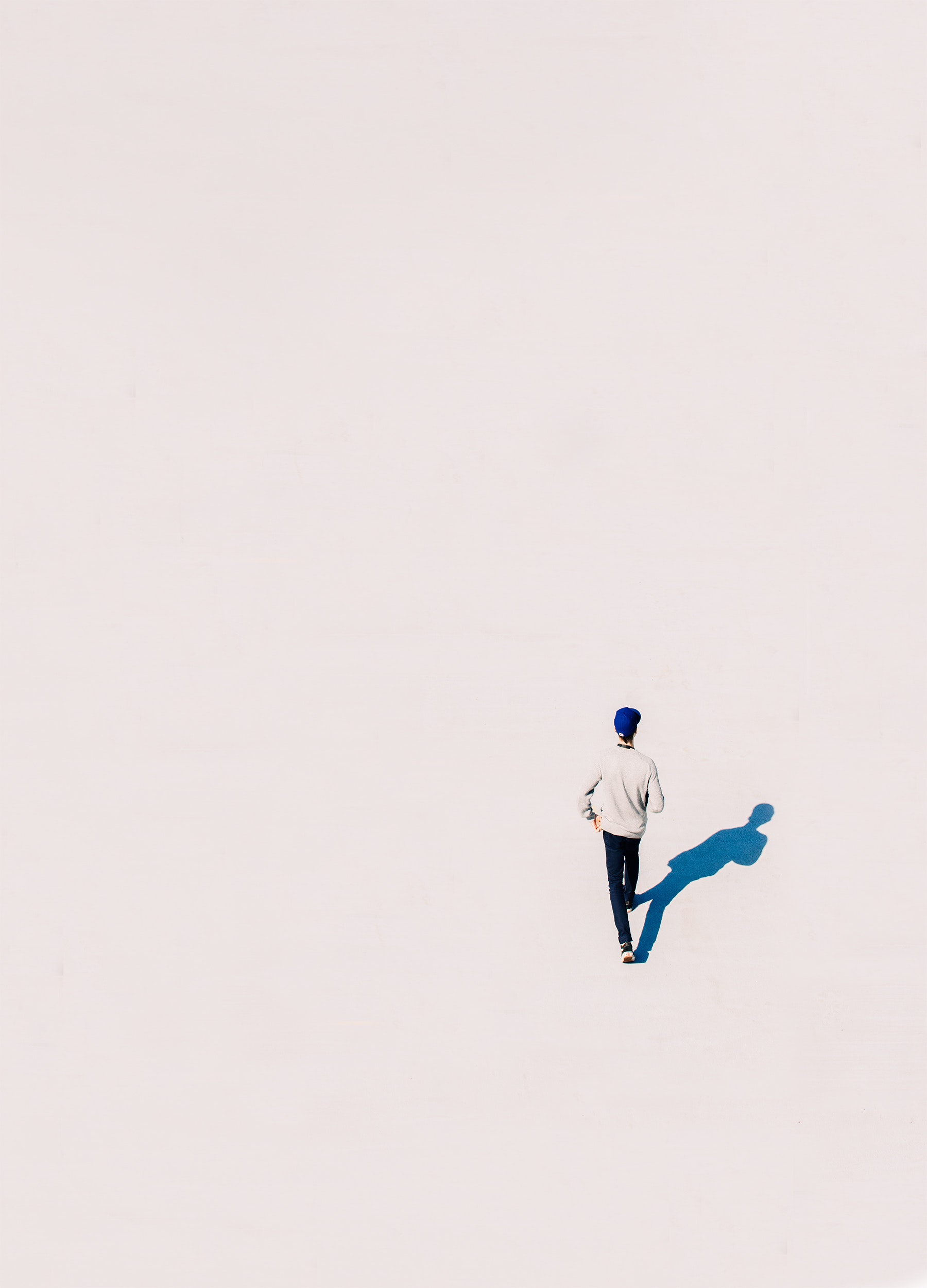 person walking on white background with shadow
