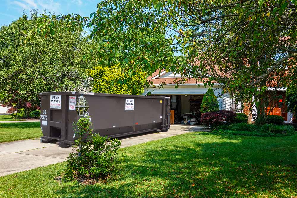 Penn Waste dumpster in residential driveway