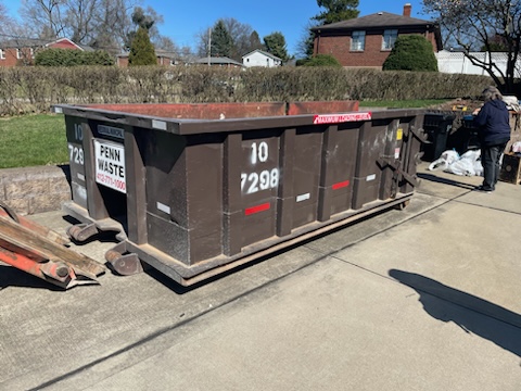 10 yard dumpster from Penn Waste in driveway