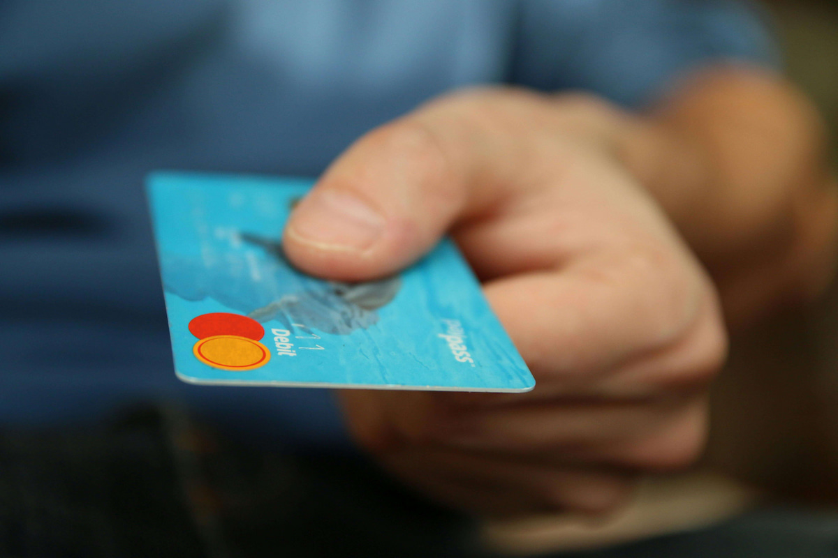 closeup of a hand holding a credit card