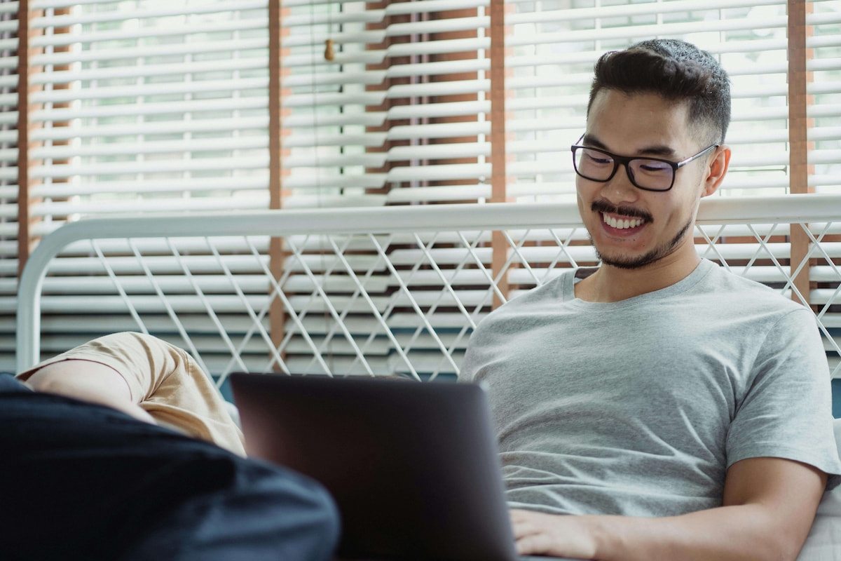 man smiling using laptop