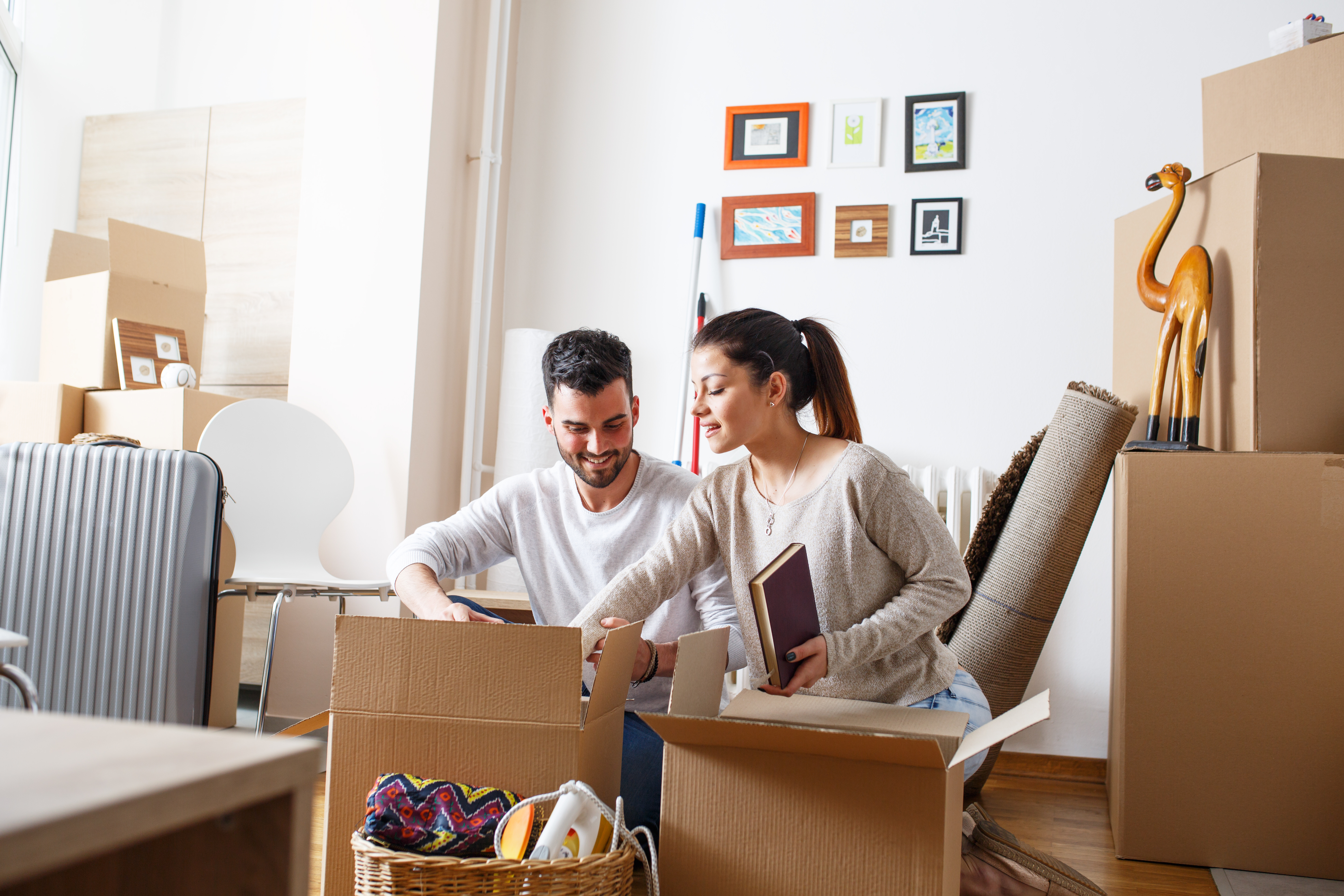 couple unboxing belongings in a new home