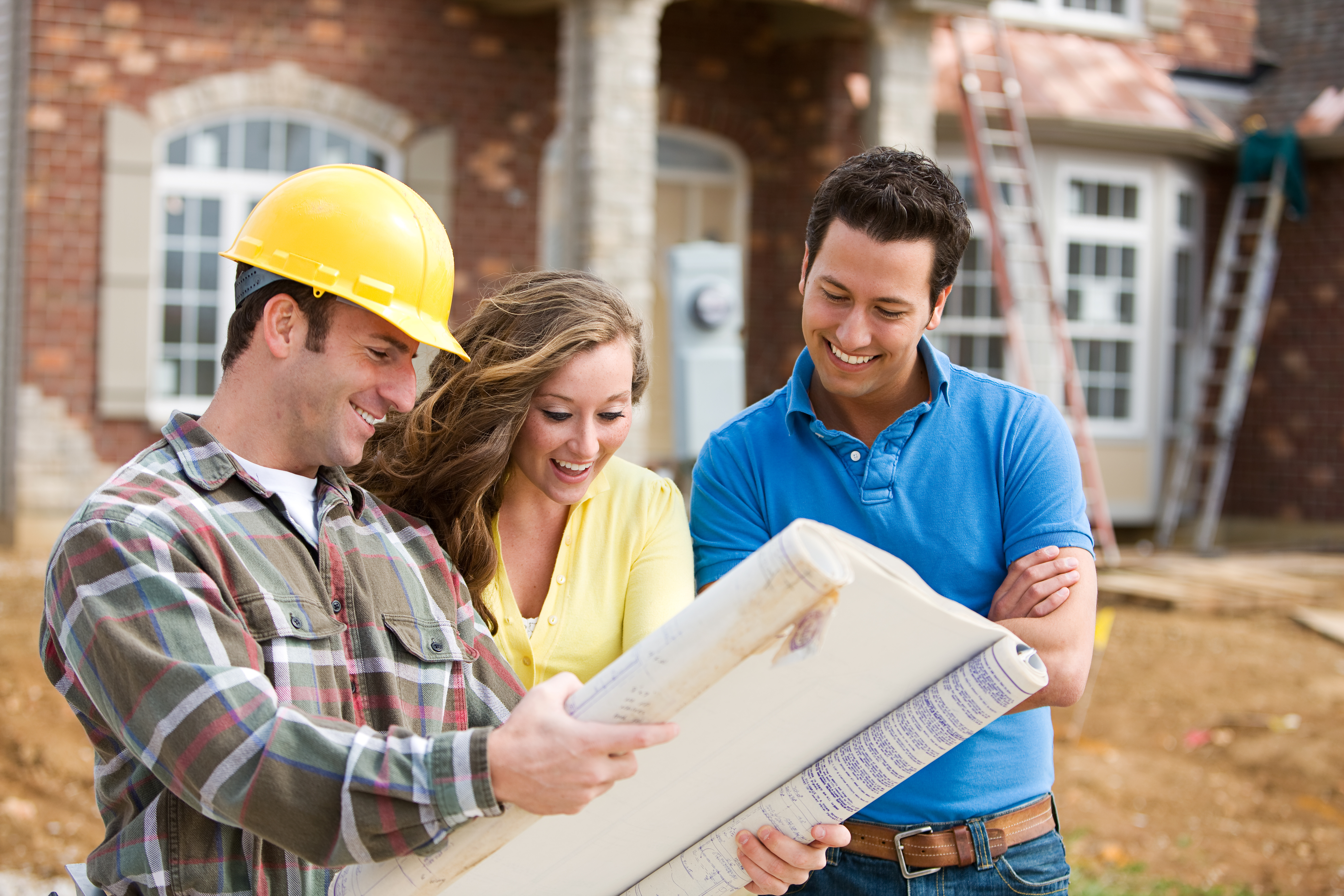 construction foreman showing homebuyers their new home plans