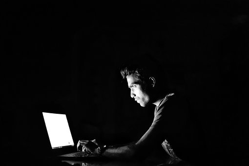 male computer hacker in front of computer
