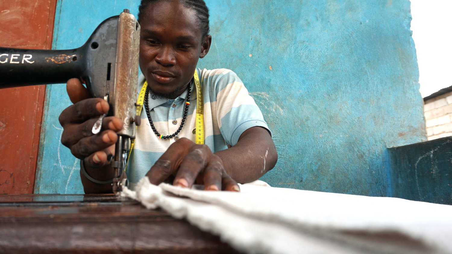 Man sewing fabric