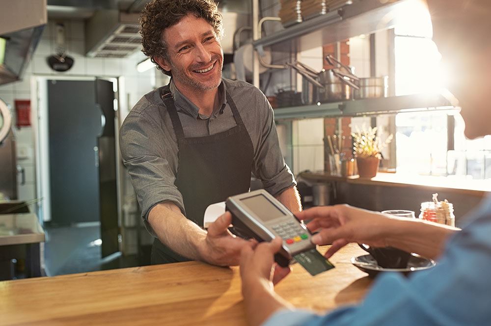 Merchant and customer completing a transaction with a credit card