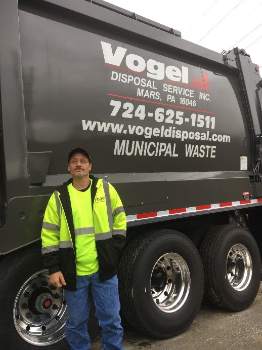 driver in front of vogel disposal service garbage truck